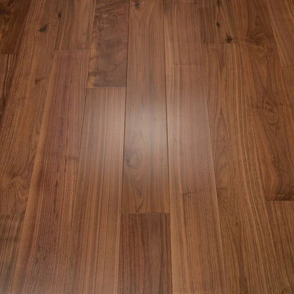 Walnut hardwood flooring planks with visible natural wood grain patterns and knots, arranged in a plank layout with a satin finish.