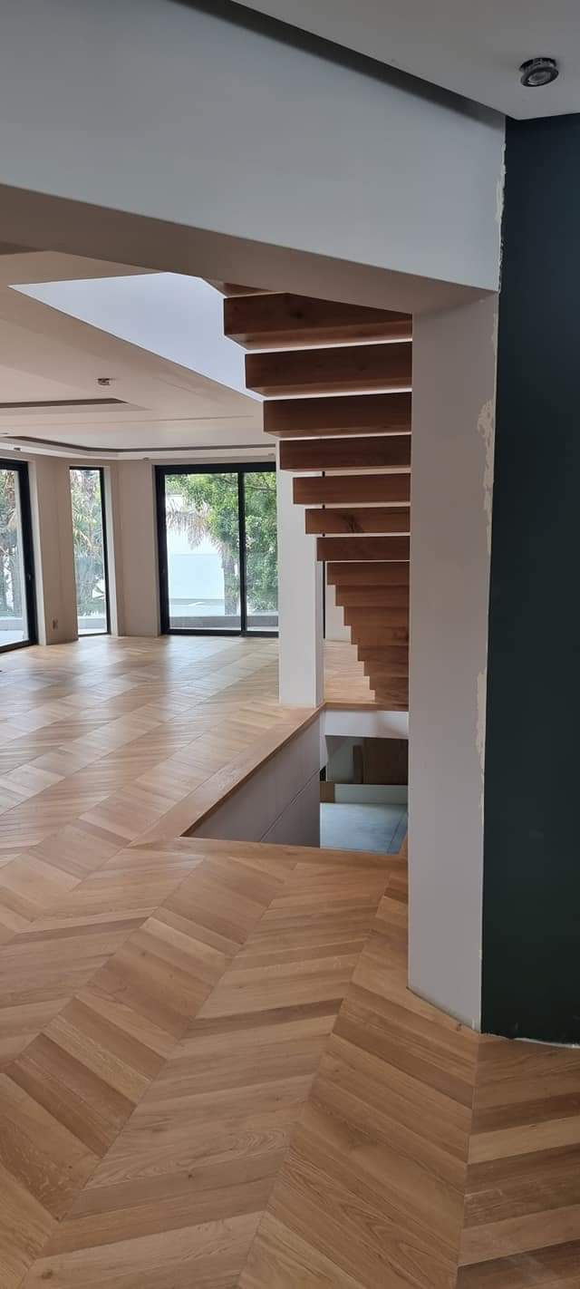 Chevron pattern oak flooring in modern Vilamoura interior – installed and finished