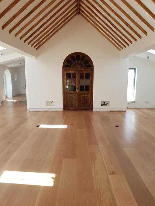 Gilt arched door and finished wood flooring